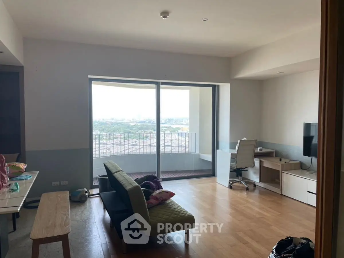 Spacious living room with balcony and city view, modern furniture and natural light