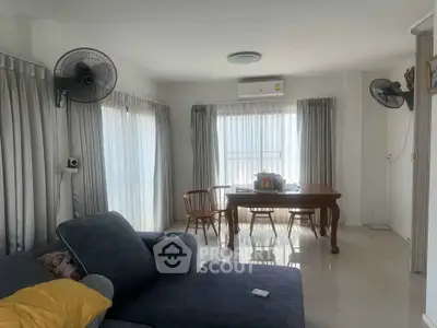 Bright living room with modern furniture and large windows for natural light.