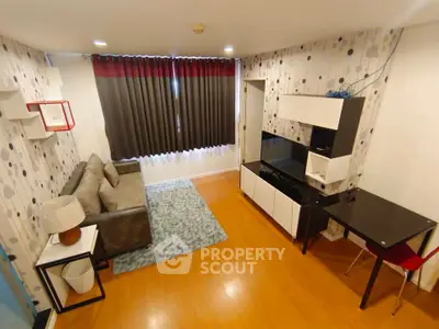Modern living room with stylish decor, cozy sofa, and sleek furniture in a well-lit apartment.