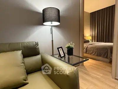 Modern living room with cozy green sofa and stylish bedroom view