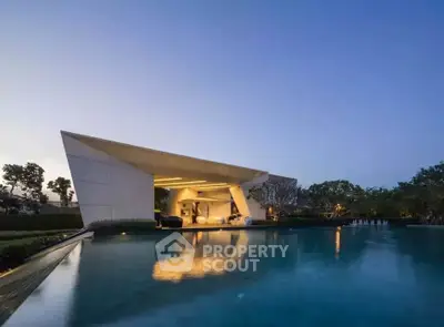 Luxurious modern villa with stunning pool and unique architectural design at sunset.