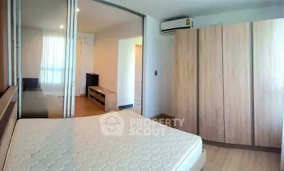 Modern bedroom with wooden wardrobe and air conditioning in a cozy apartment.