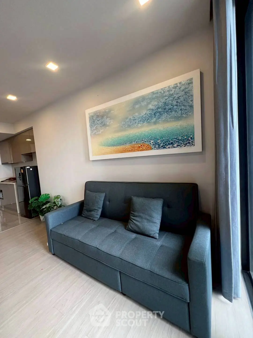 Modern living room with stylish sofa and abstract wall art in a cozy apartment.