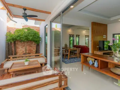 Spacious open-plan living area with wooden furniture and indoor-outdoor flow