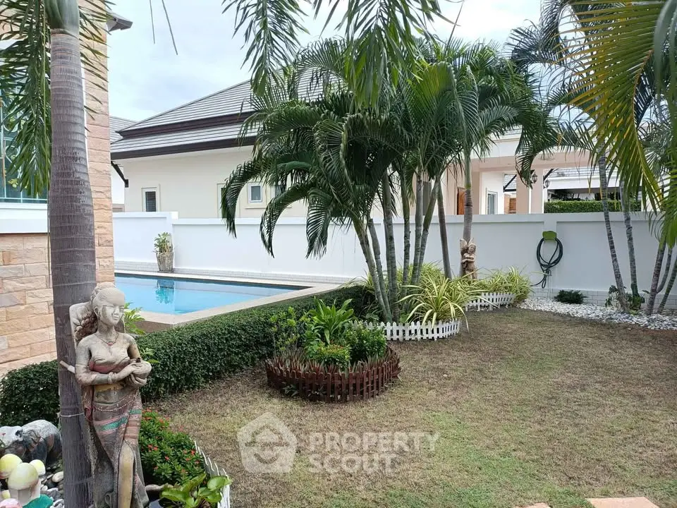 Tropical garden with pool and lush greenery in a serene residential setting.