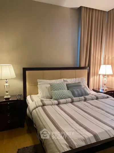 Luxurious bedroom with elegant decor and ambient lighting, featuring a plush bed and stylish bedside tables.
