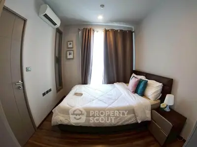Cozy bedroom with modern decor and natural light in a stylish apartment.