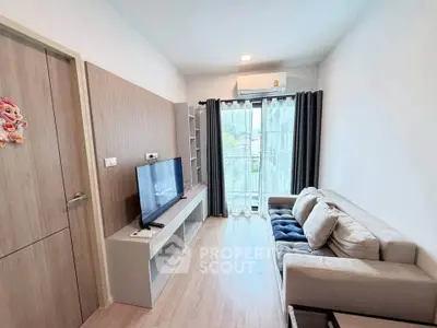 Modern living room with sleek design, featuring a cozy sofa, flat-screen TV, and large window for natural light.