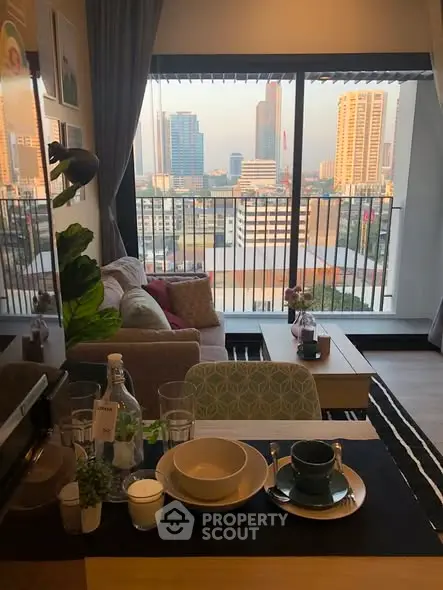 Modern living room with city view, stylish decor, and cozy seating area in urban apartment.