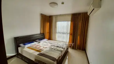 Cozy bedroom with modern decor and large window for natural light