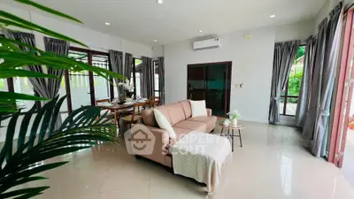 Spacious living room with elegant decor and garden view, perfect for modern family living.