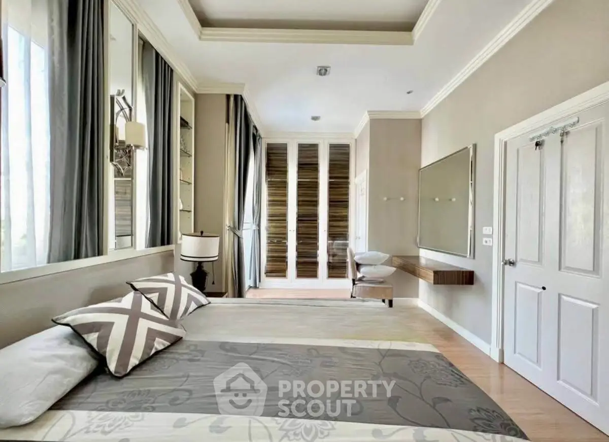 Luxurious bedroom with elegant decor and ample natural light