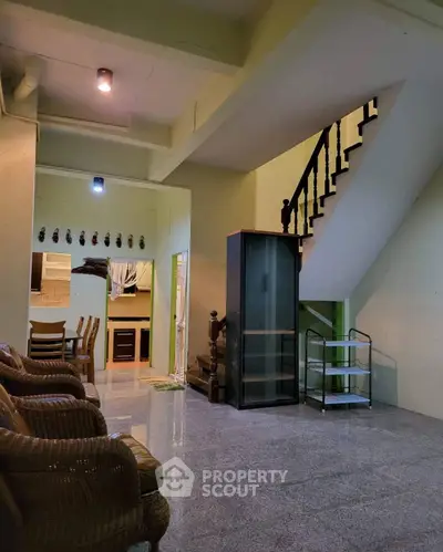 Spacious living area with staircase and dining space in modern home
