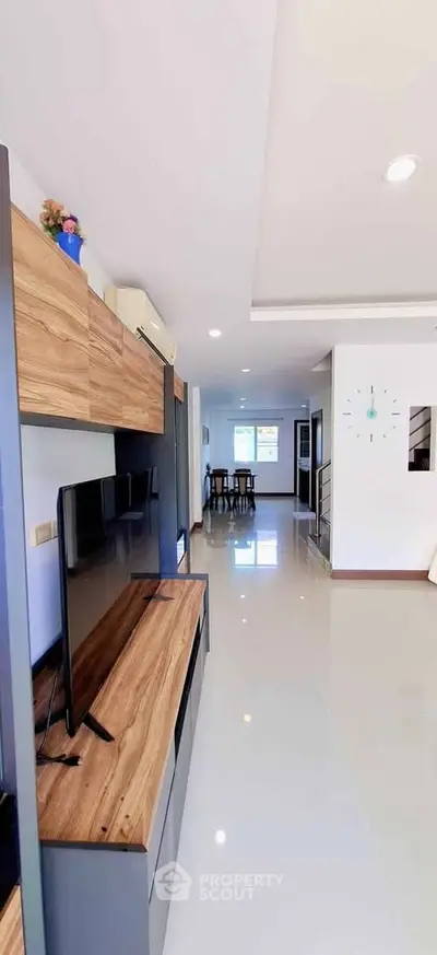 Spacious modern living room with sleek wooden furniture and open layout