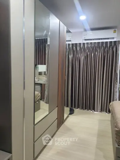 Modern bedroom with mirrored wardrobe and elegant curtains
