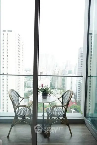 Stunning high-rise balcony with city view, perfect for relaxation and enjoying the skyline.