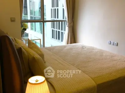 Cozy bedroom with large window and elegant decor in modern apartment