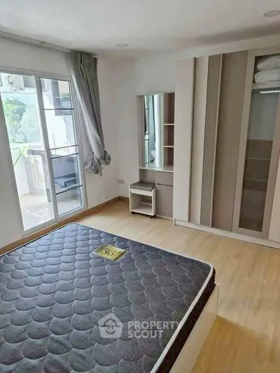 Spacious bedroom with modern design and balcony access