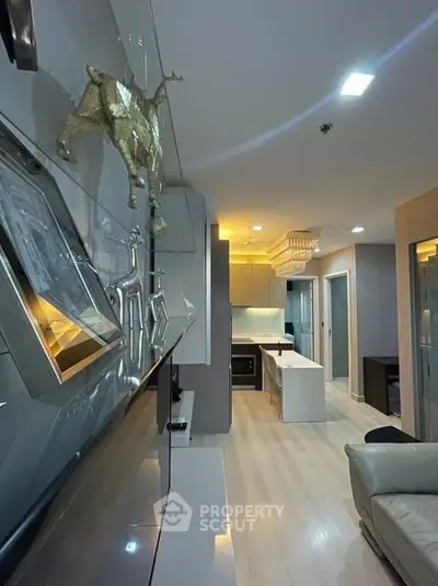 Modern living room with sleek decor and open kitchen layout in a stylish apartment.