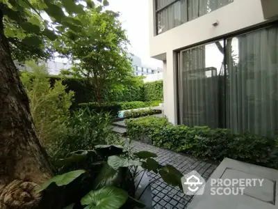 Modern garden view with lush greenery and sleek building facade