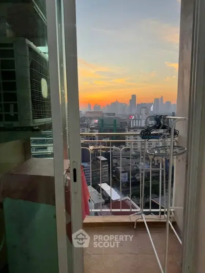 Stunning cityscape view from a high-rise balcony at sunset, perfect for urban living enthusiasts.