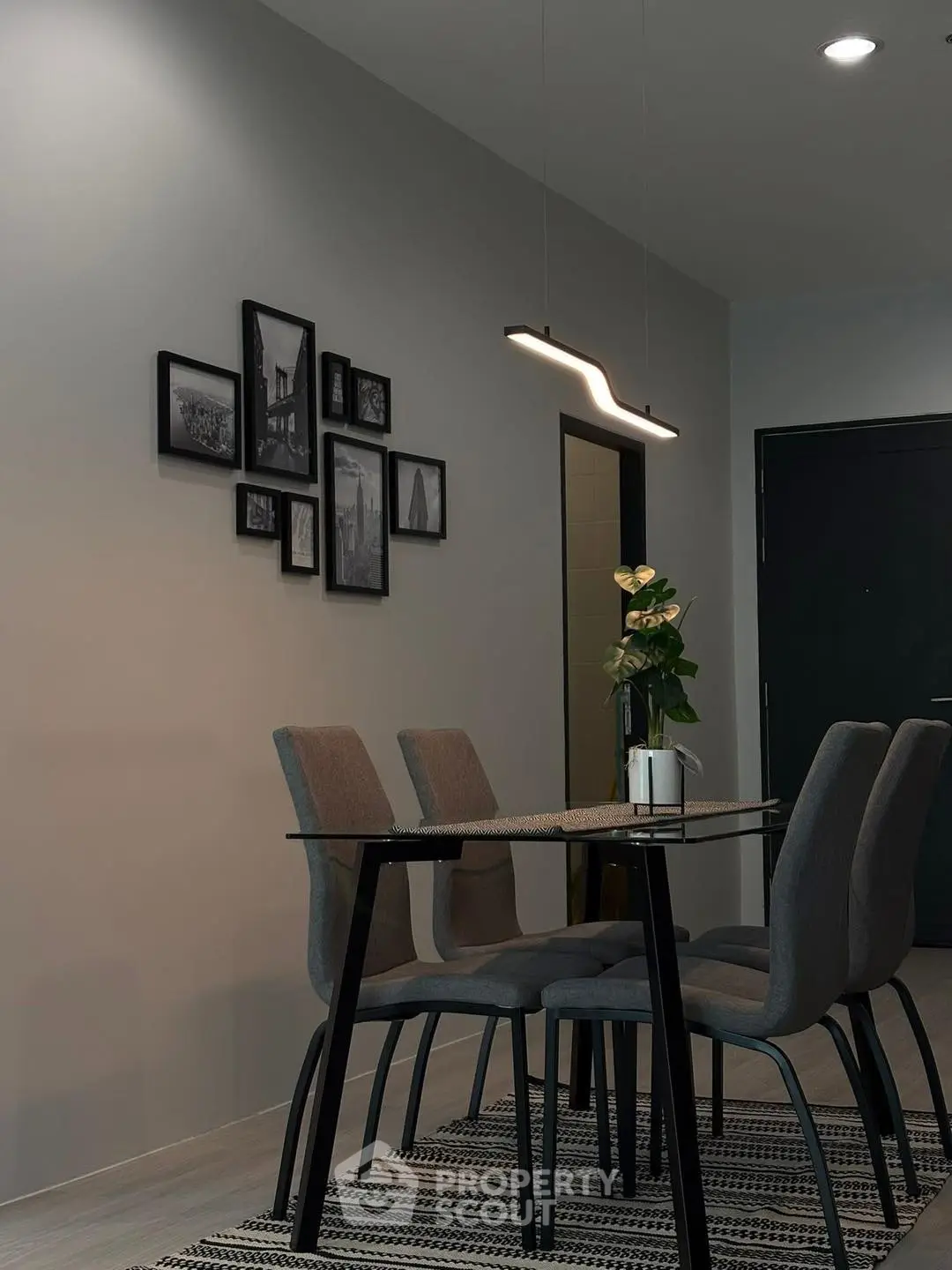 Modern dining area with stylish glass table and elegant lighting