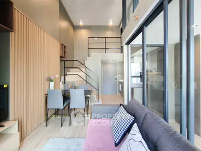 Modern duplex living room with stylish decor and high ceilings