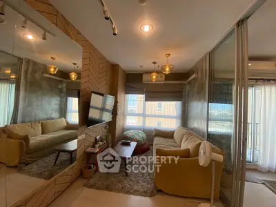 Stylish living room with modern decor and large mirror reflecting cozy ambiance.