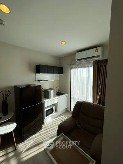 Cozy apartment kitchen with modern appliances and comfortable seating area