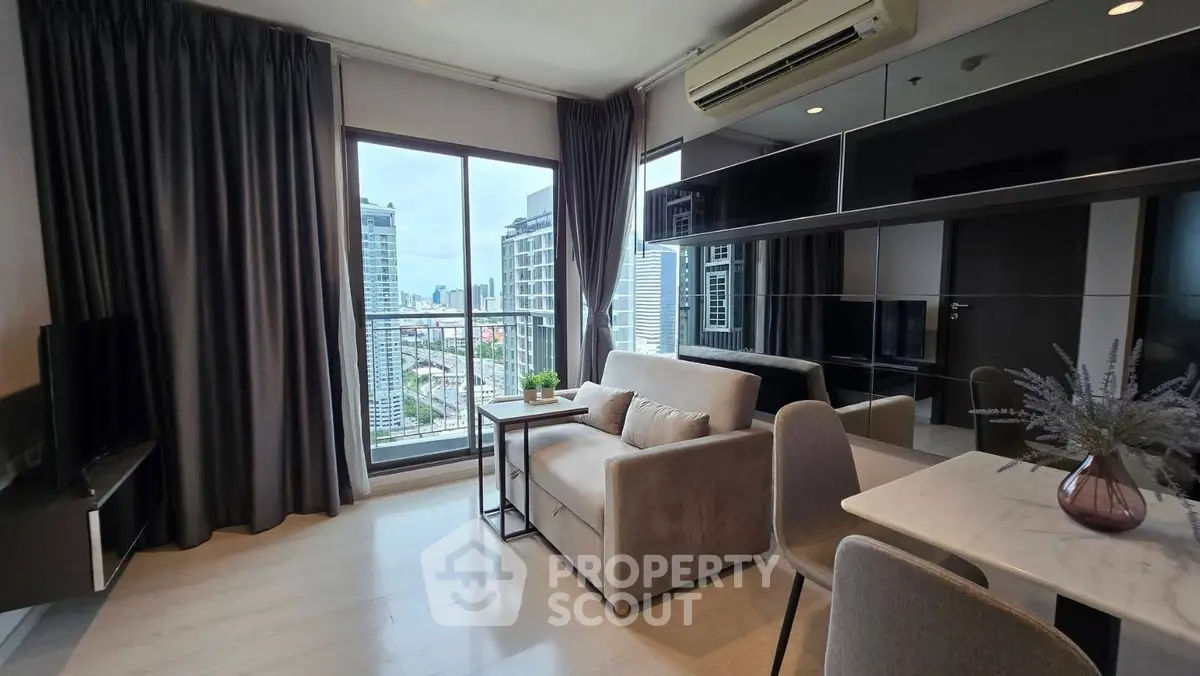 Modern living room with city view, sleek furniture, and large windows in a high-rise apartment.