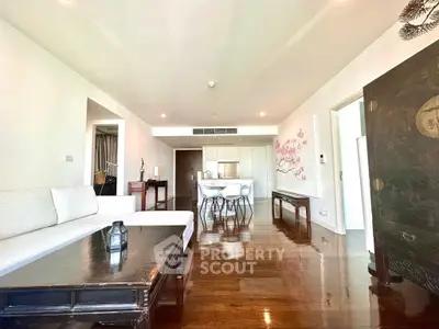 Spacious open-plan living room with elegant decor and hardwood floors