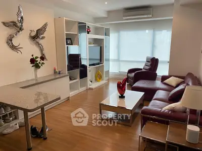 Stylish living room with modern decor and red leather sofa in a bright apartment.