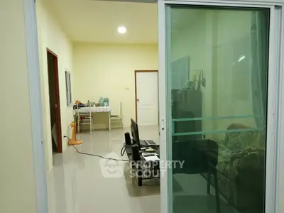 Spacious living room with sliding glass doors and modern furnishings in a cozy apartment.