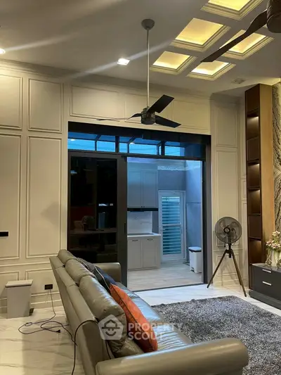 Luxurious living room with modern ceiling fan and stylish decor