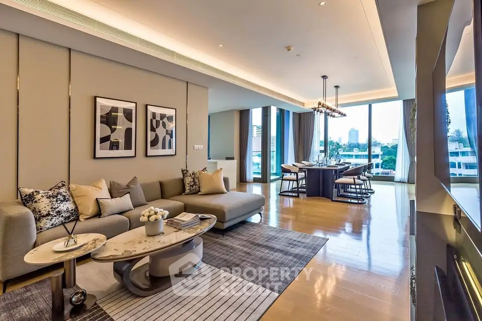Luxurious modern living room with elegant decor and spacious dining area, featuring floor-to-ceiling windows.