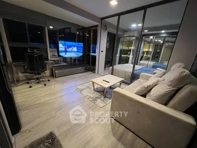 Modern living room with sleek design, featuring a cozy sofa, stylish coffee table, and large TV, perfect for relaxation.