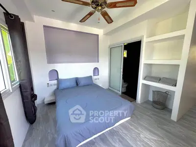 Modern bedroom with stylish ceiling fan and built-in shelves, featuring a cozy bed and elegant decor.