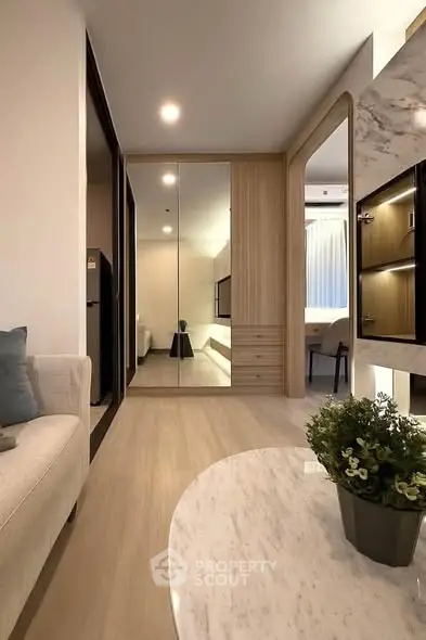 Modern living room with sleek design and mirrored closet doors