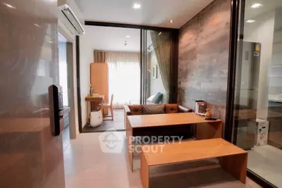 Modern living room with stylish wooden furniture and large windows for natural light.