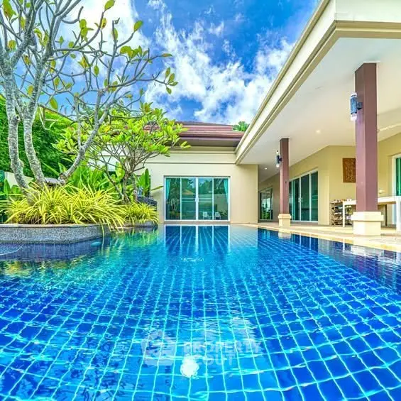 Luxurious villa with stunning pool and lush garden, perfect for relaxation and entertainment.