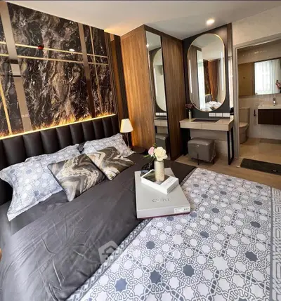 Luxurious bedroom with elegant decor and ensuite bathroom, featuring modern design and cozy ambiance.