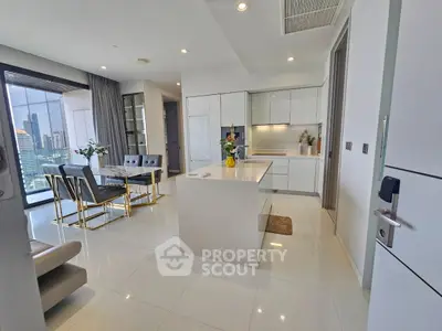 Luxurious open-plan kitchen and living area with city view, modern furnishings, and elegant decor.