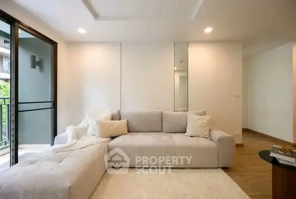 Modern living room with cozy sectional sofa and balcony view