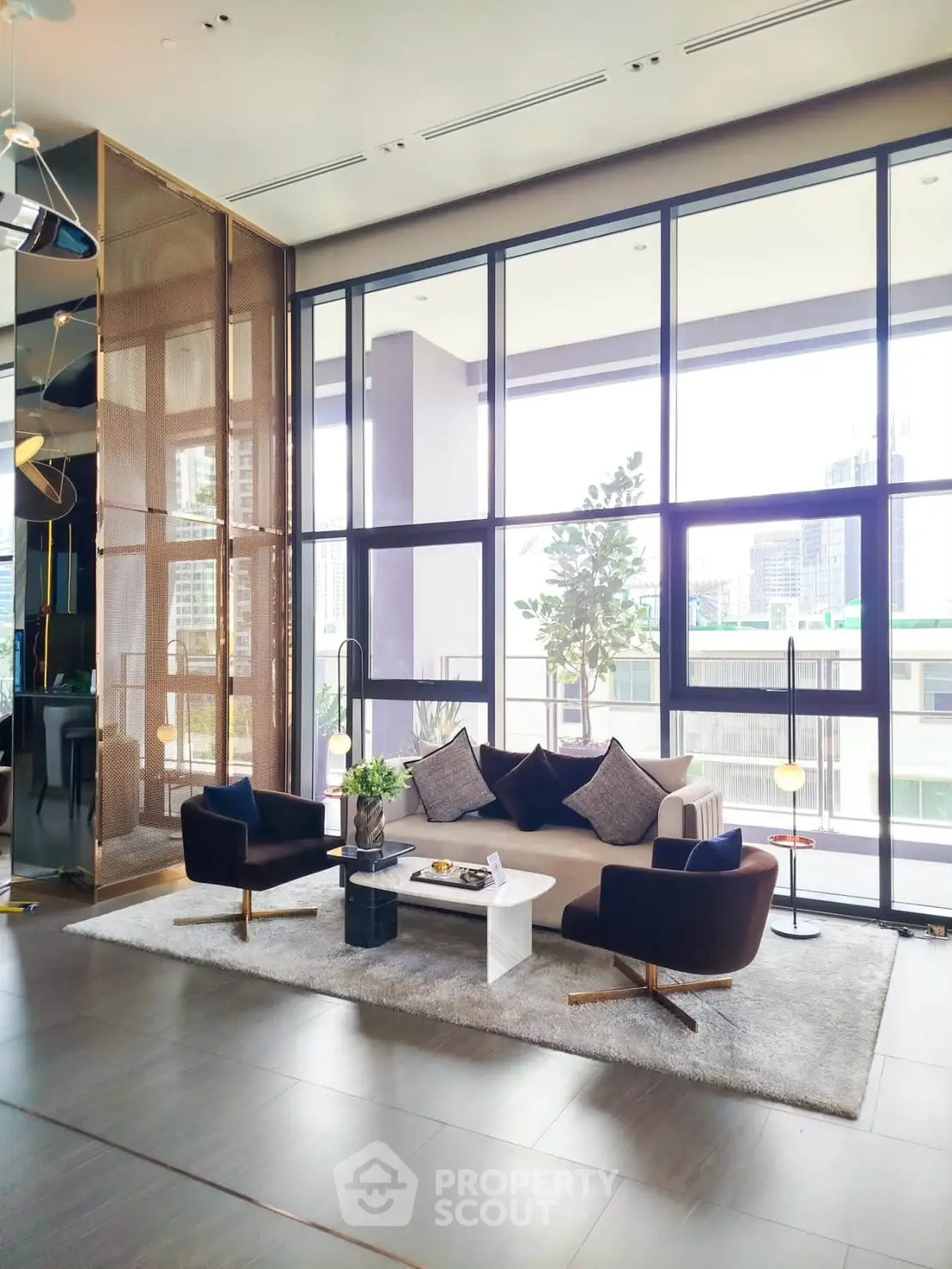 Luxurious modern living room with floor-to-ceiling windows and stylish decor in a high-rise apartment.