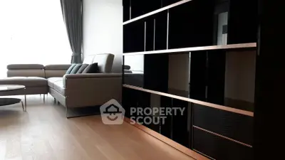 Modern living room with sleek furniture and elegant shelving unit