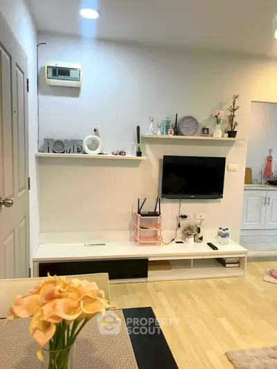 Charming living room with modern decor and wall-mounted TV, perfect for cozy gatherings.