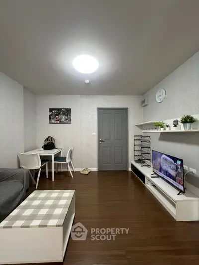 Modern living room with sleek furniture and wall-mounted TV, perfect for cozy evenings.