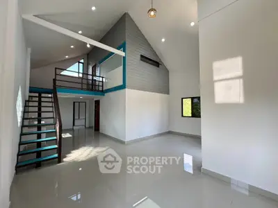 Spacious modern living room with high ceiling and loft area