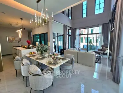 Luxurious open-plan living and dining area with high ceilings and elegant decor.