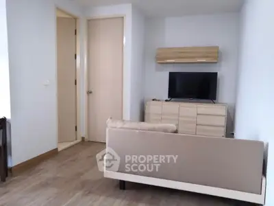 Modern living room with sleek furniture and mounted TV in stylish apartment